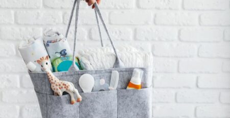 Mom holding a diaper bag filled with newborn essentials