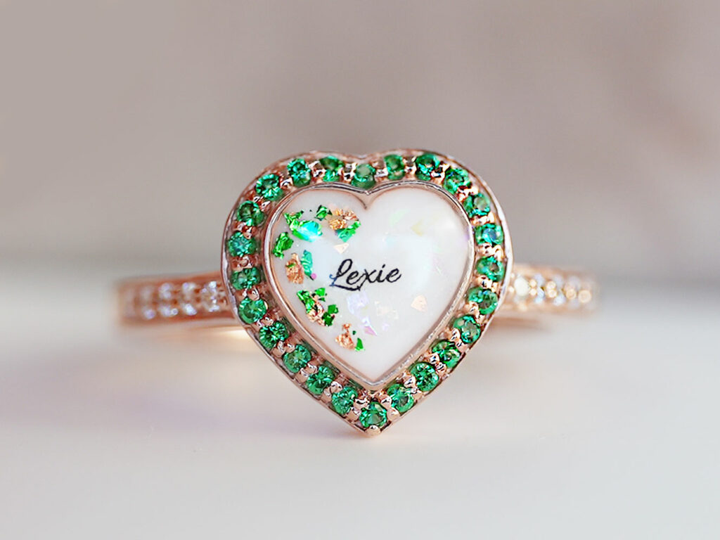 breastmilk jewelry rose gold heart shaped ring with may emerald birth month color crystals gems around breastmilk central stone from keepsakemom