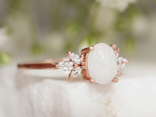 breastmilk ring burst of love oval with three crystals on each side from KeepsakeMom with crushed opal gems in the milk stone side view