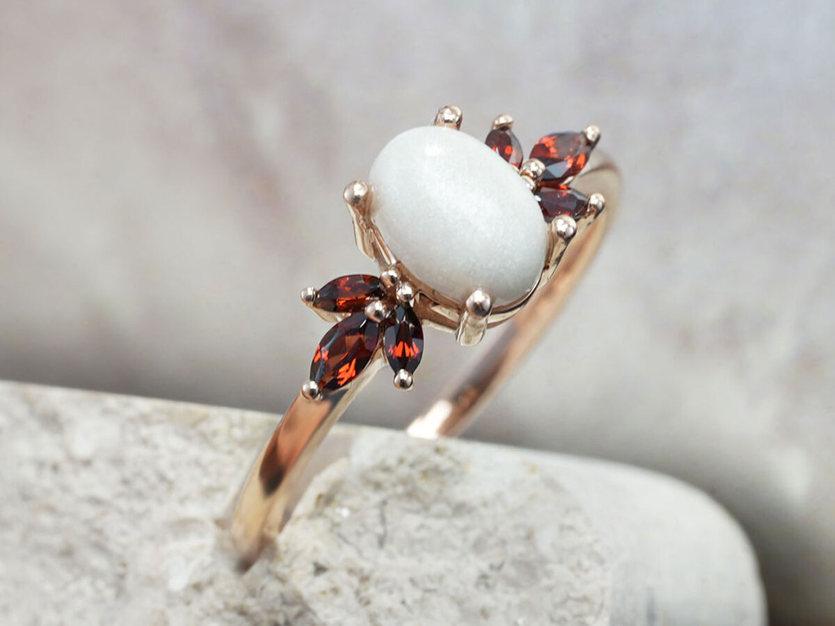 breastmilk ring burst of love oval with three garnet crystals on each side from KeepsakeMom with oval breastmilk stone side view