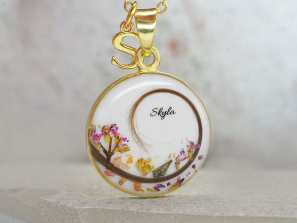 breastmilk jewelry disc necklace with lock of hair swirl and flowers colorful from keepsakemom