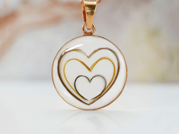 breastmilk jewelry large disc filled with breastmilk and three hearts one within another made with hair from keepsakemom