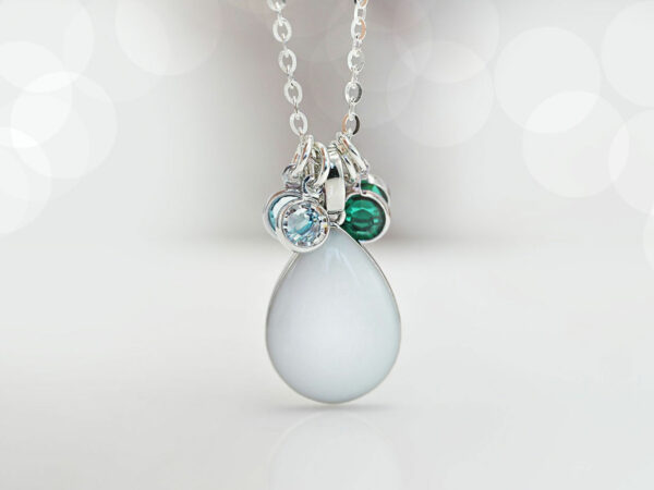 breastmilk jewelry teardrop pear shaped necklace in sterling silver on white background with 4 charms green and light blue from keepsakemom