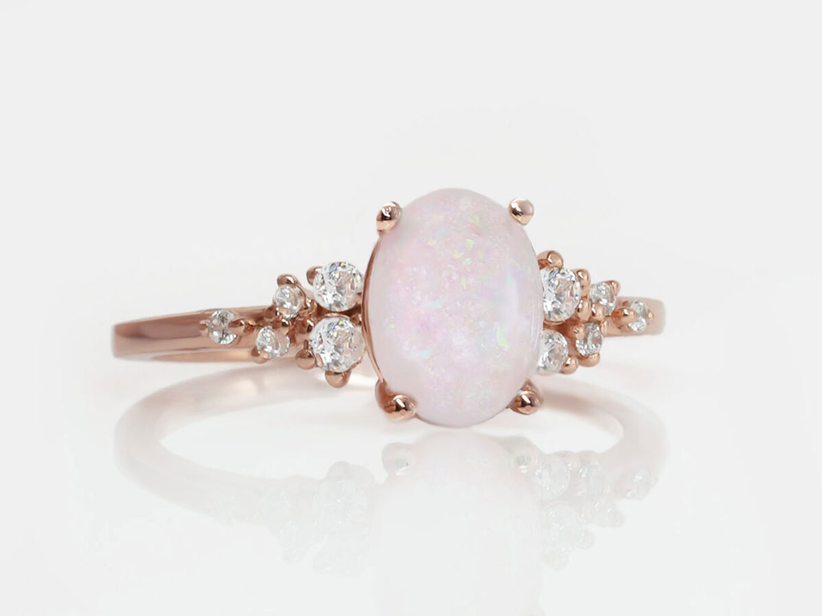 breastmilk oval stone ring with crushed pink opal gems and clear crystals and rose gold setting from keepsakemom