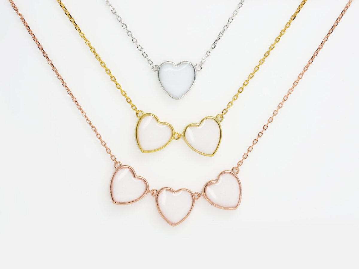DIY breastmilk jewelry three heart necklaces in different color metals rose gold, yellow gold and silver for DIY kit from KeepsakeMom simple on white background