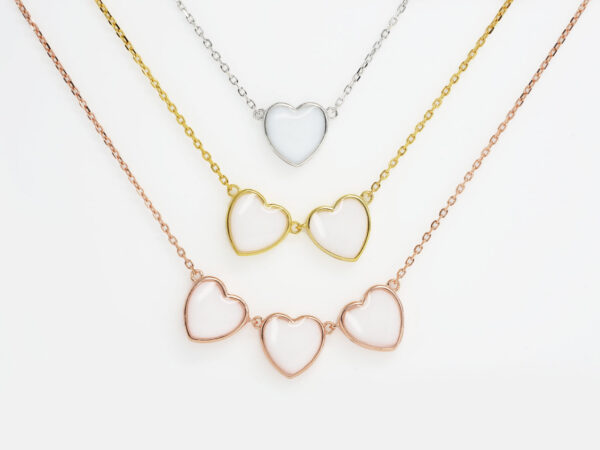 DIY breastmilk jewelry three heart necklaces in different color metals rose gold, yellow gold and silver for DIY kit from KeepsakeMom simple on white background
