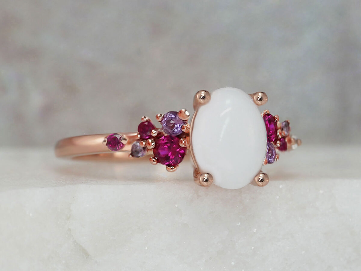 breastmilk jewelry silver ring diamond shaped milk stone and five gems on each side purple and ruby birth month colors from KeepsakeMom