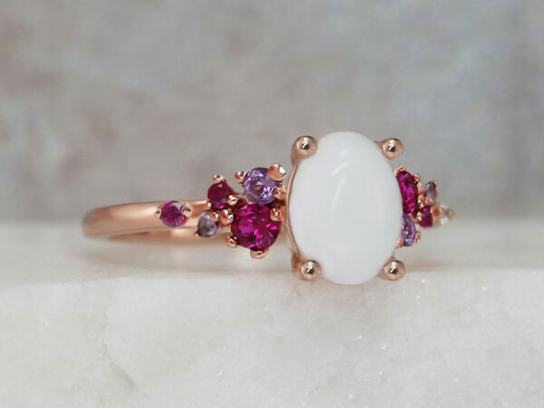 breastmilk jewelry silver ring diamond shaped milk stone and five gems on each side purple and ruby birth month colors from KeepsakeMom