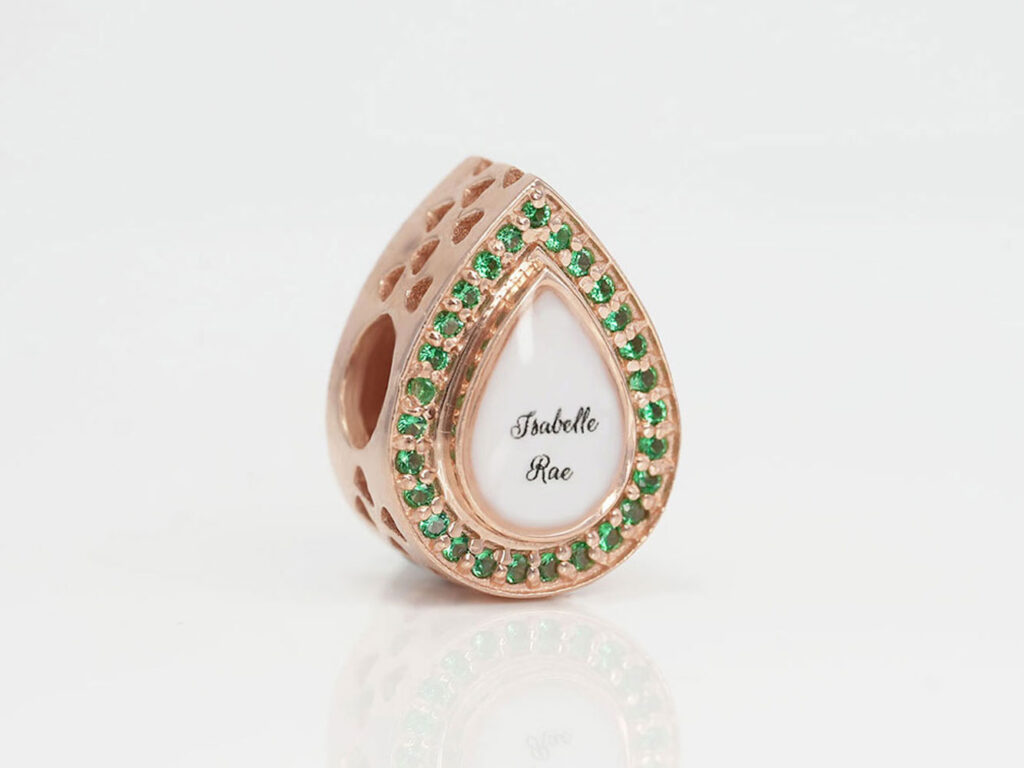 breastmilk jewelry charm for Pandora with may emerald birth month color crystals gems around breastmilk center from keepsakemom