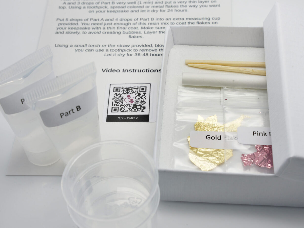 DIY kit breast milk jewelry open box contents from KeepsakeMom gold and pink flakes