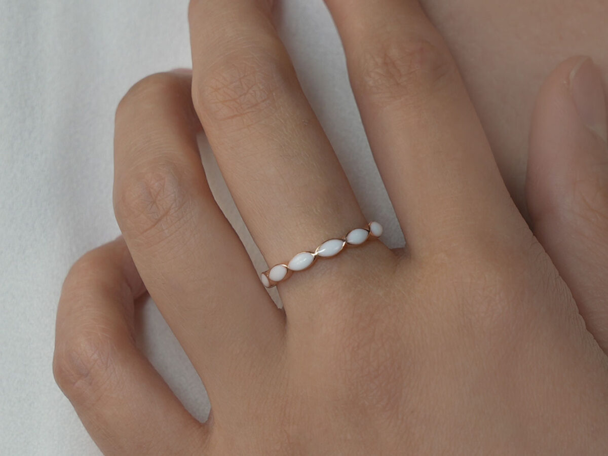 breastmilk jewelry ring on a model hand close-up in rose gold