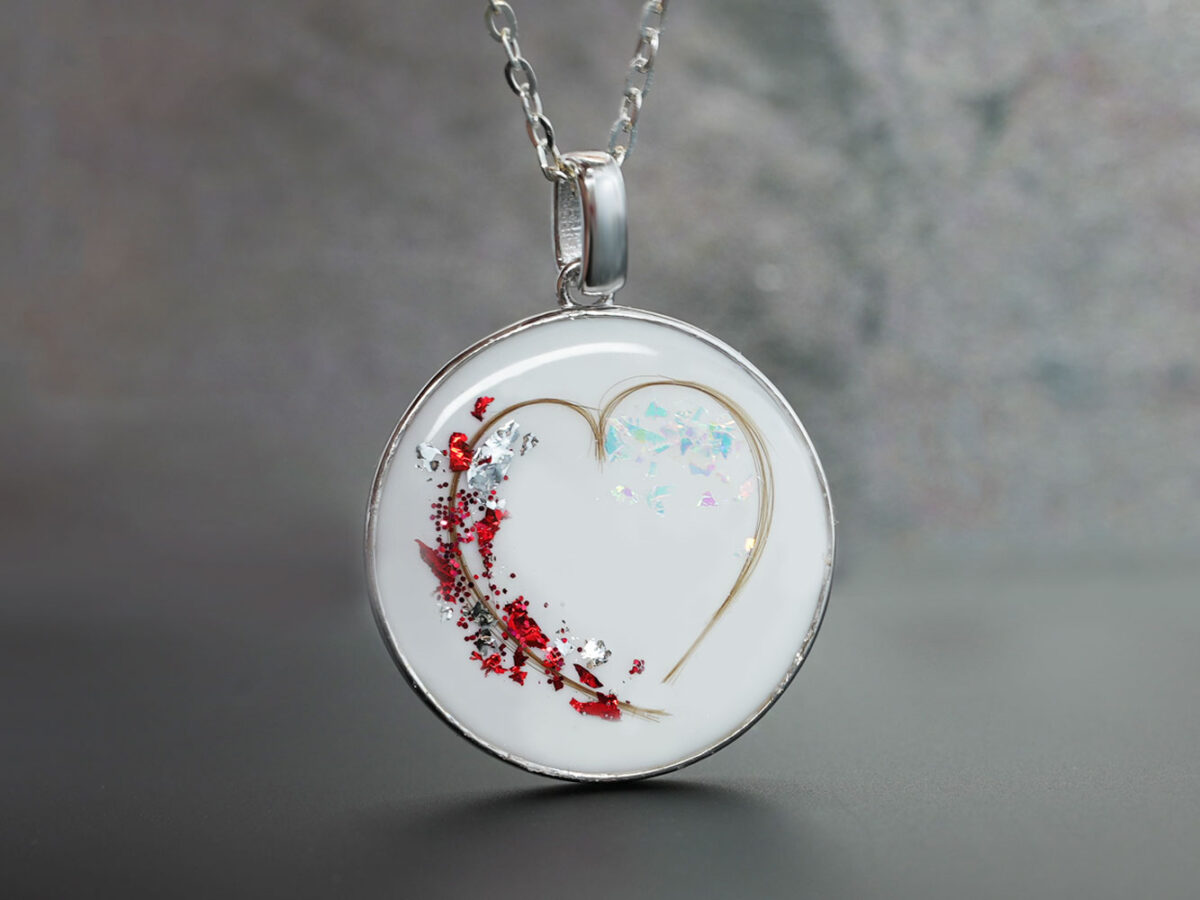 breastmilk jewelry sterling silver disc filled with breast milk and heart made with baby's hair and red flakes from KeepsakeMom