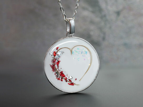 breastmilk jewelry sterling silver disc filled with breast milk and heart made with baby's hair and red flakes from KeepsakeMom