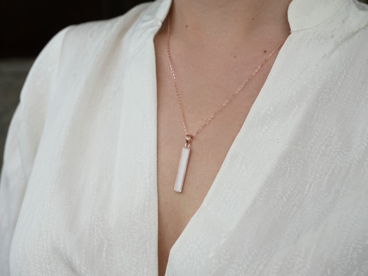 breastmilk bar simple necklace in rose gold on model chest side view
