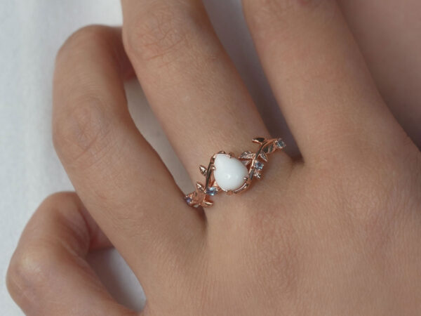breastmilk jewelry ring teardrop ring on a model hand flower shape pink yellow gems from keepsakemom
