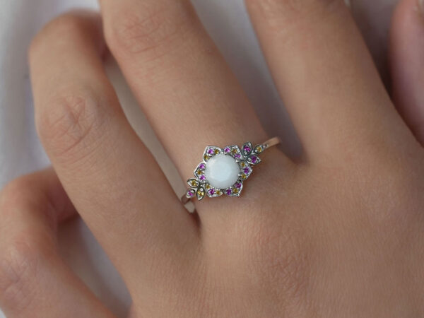 breastmilk jewelry ring flower ring on a model hand flower shape pink yellow gems from keepsakemom