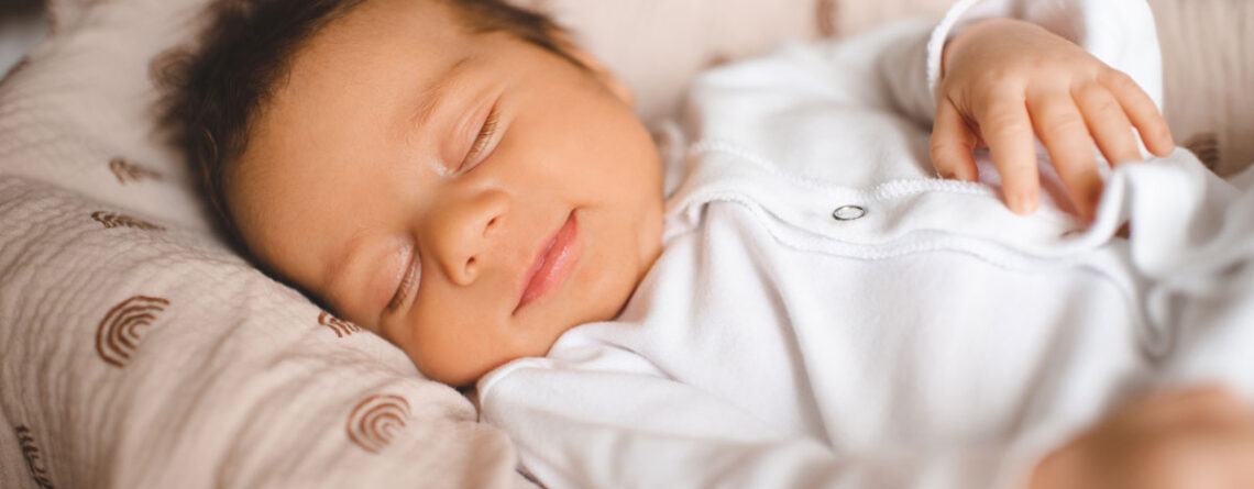 Smiling sleeping infant