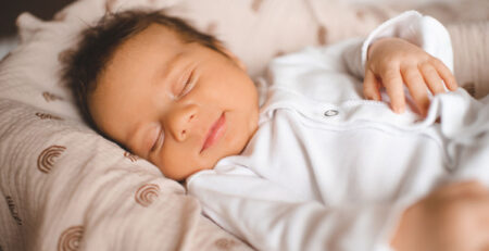 Smiling sleeping infant