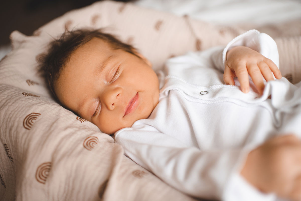 Smiling sleeping infant