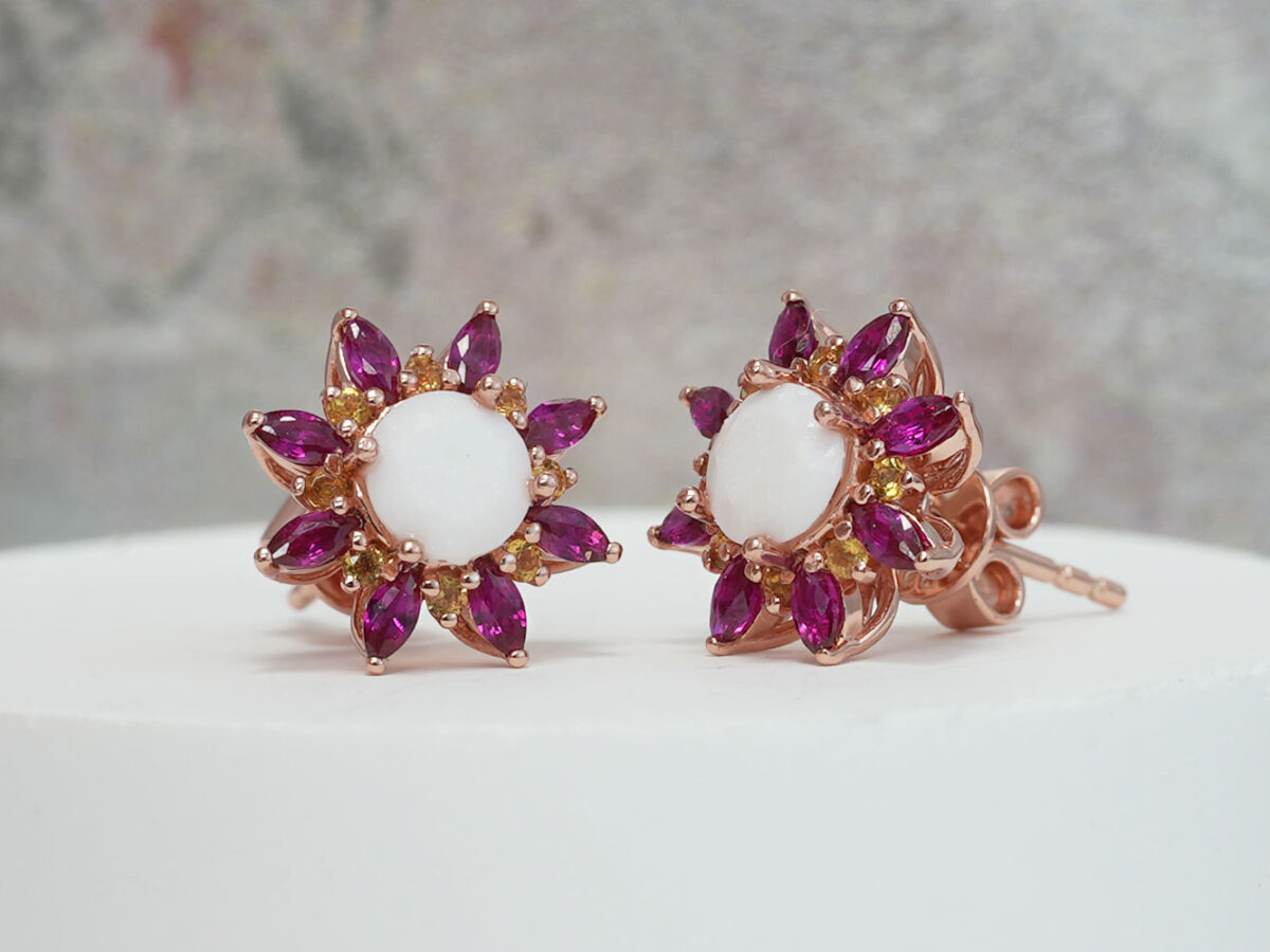 breastmilk jewelry fancy star or flower shaped studded earrings with birth month colored gems ruby as leaves from KeepsakeMom on white background