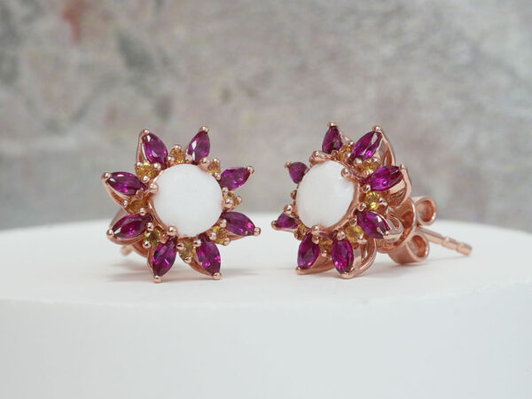 breastmilk jewelry fancy star or flower shaped studded earrings with birth month colored gems ruby as leaves from KeepsakeMom on white background