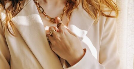 Close-up of woman wearing gold jewelry