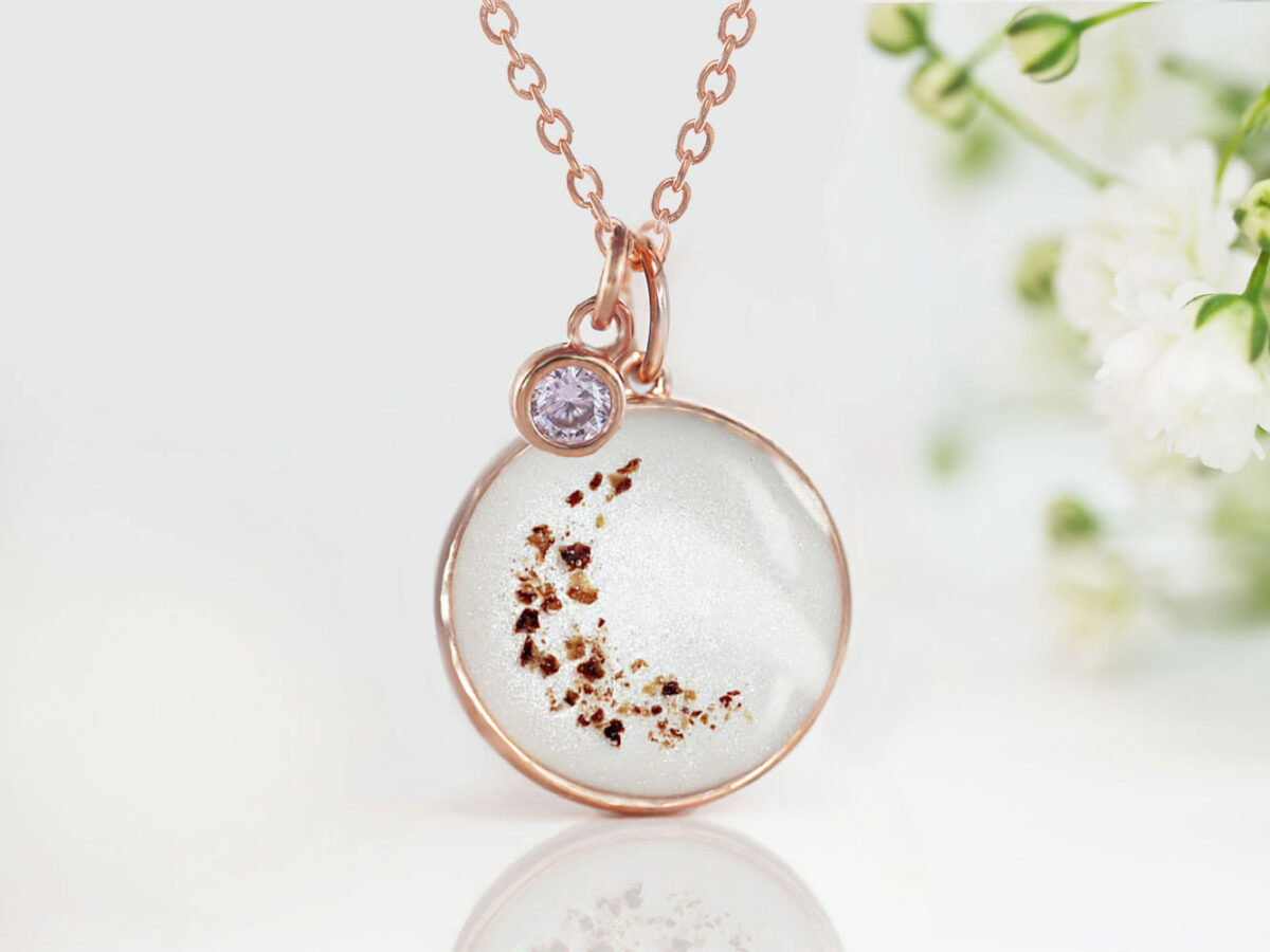 breastmilk jewelry disc necklace pendant from keepsakemom in a 18mm disc filled with breastmilk, with placenta forming crescent moon and light purple alexandrite charm for june from keepsakemom