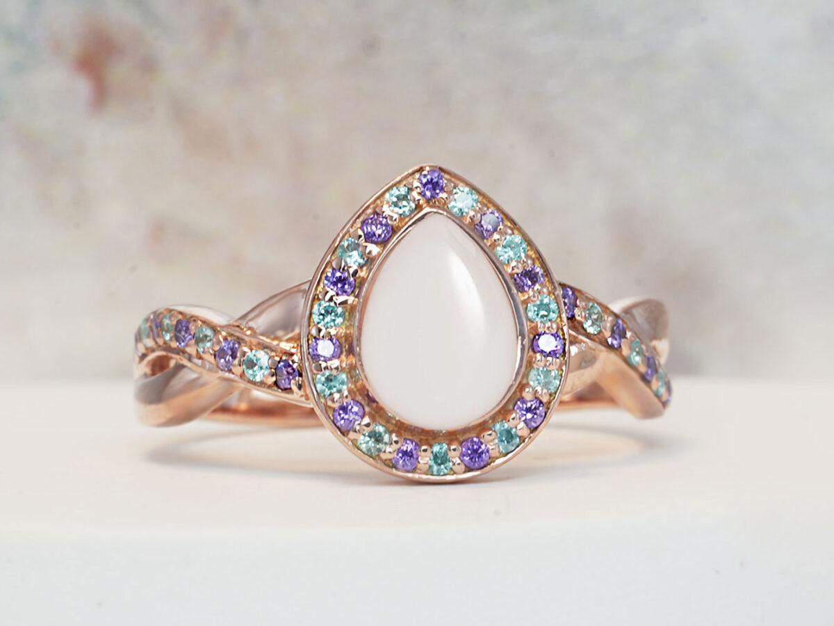 breastmilk ring for DIY KIT rose gold teardrop shaped with purple crystals around the band and stone halo from keepsakemom