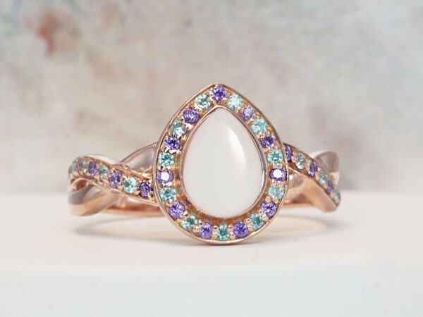 breastmilk ring for DIY KIT rose gold teardrop shaped with purple crystals around the band and stone halo from keepsakemom