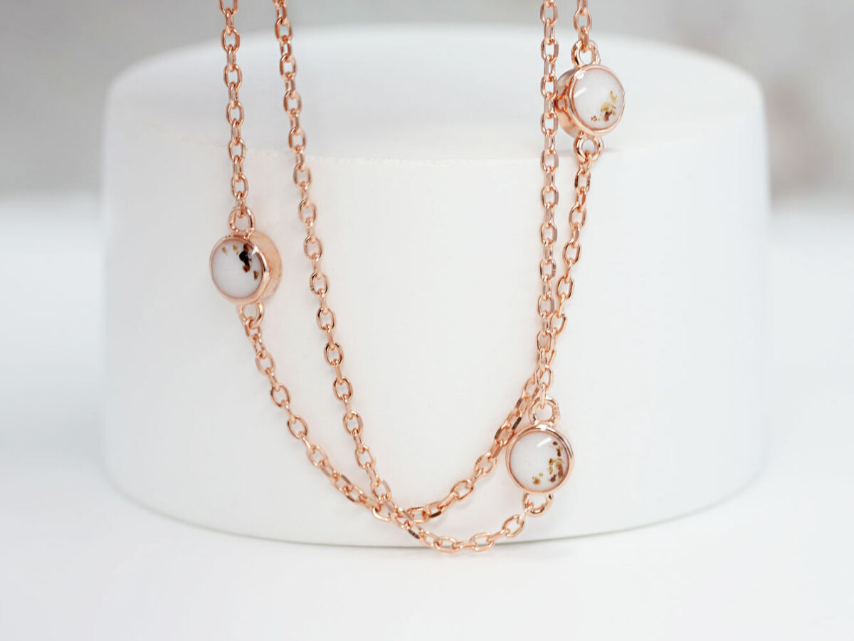 breastmilk jewelry necklace with placenta, umbilical cord and ashes in rose gold plating chain with tiny discs filled with breastmilk from keepsakemom