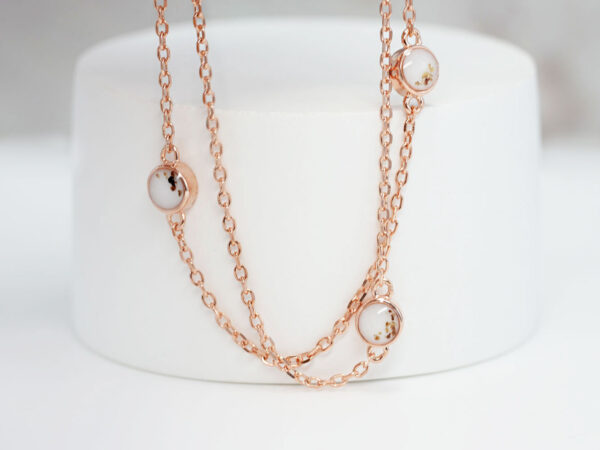 breastmilk jewelry necklace with placenta, umbilical cord and ashes in rose gold plating chain with tiny discs filled with breastmilk from keepsakemom