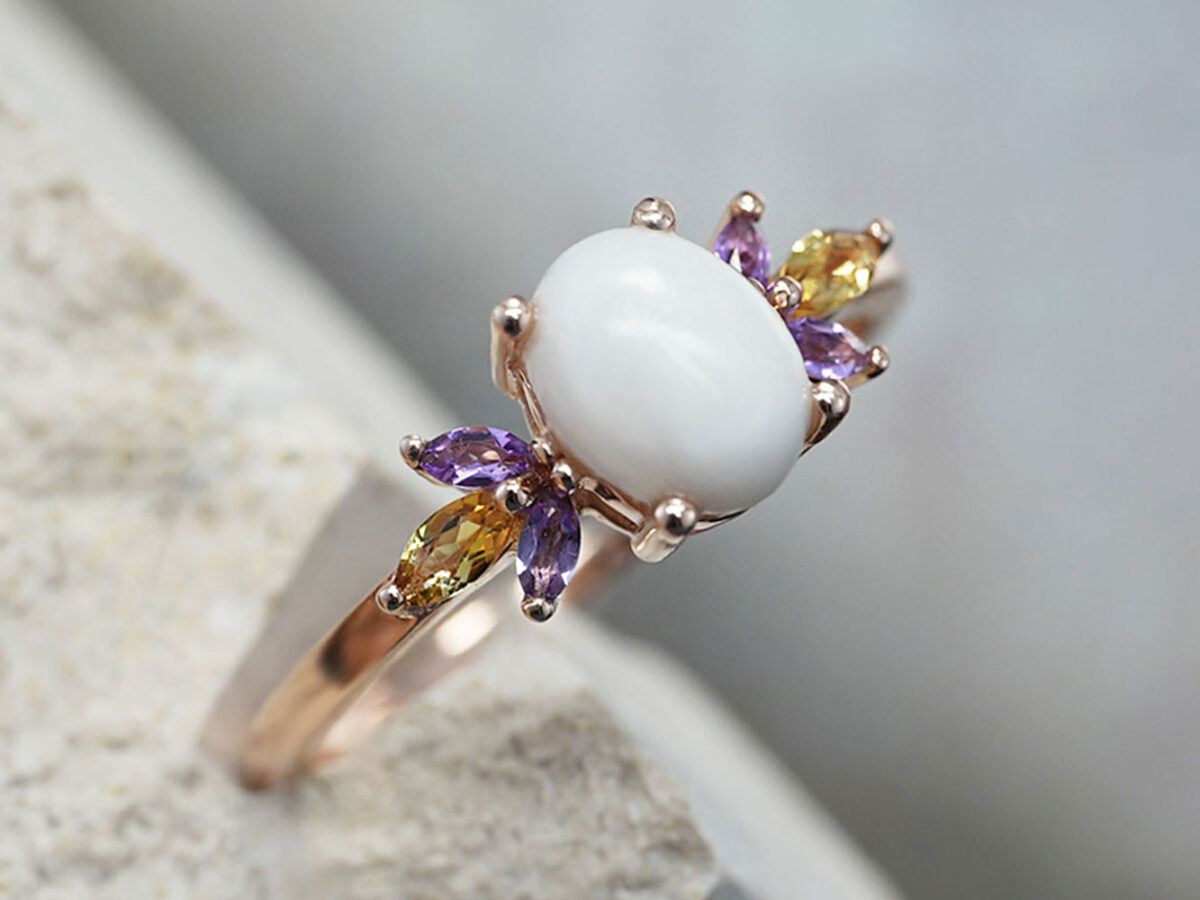 breastmilk ring burst of love oval with two purple and one yellow citrine gems on each side of oval breastmilk stone from KeepsakeMom side view