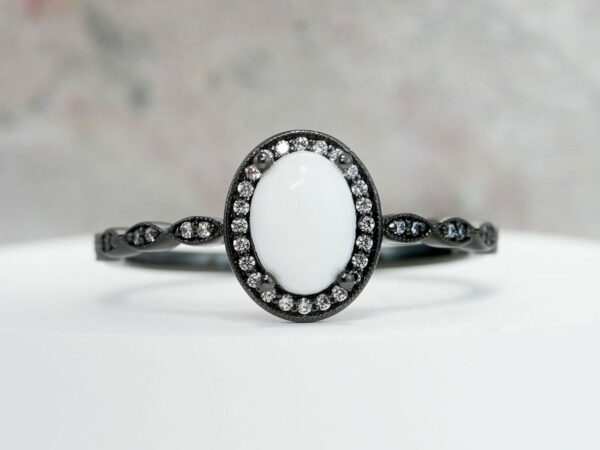 black breastmilk jewelry oval ring with clear crystals around halo from keepsakemom