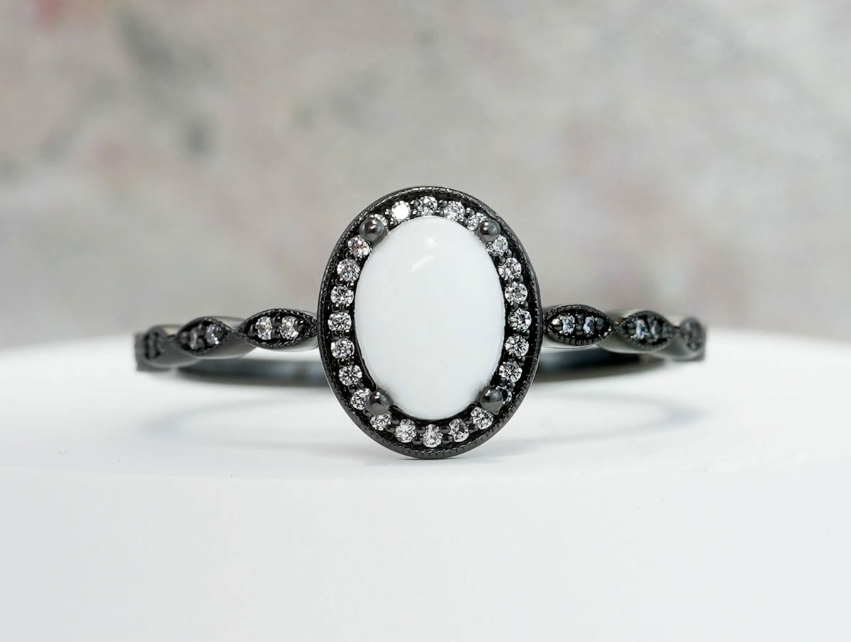 black breastmilk jewelry oval ring with clear crystals around halo from keepsakemom