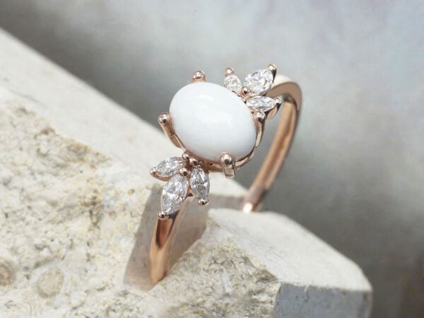 breastmilk ring burst of love oval breastmilk stone with three clear crystals on each side from KeepsakeMom side view