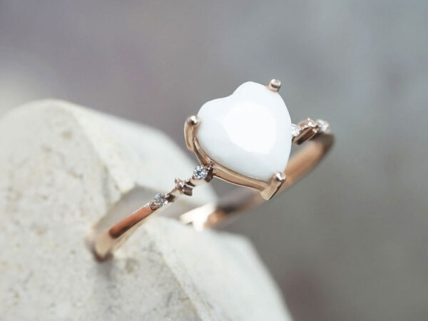 breastmilk jewelry ring in sterling silver rose gold plated with fine band and crystals on each side with heart shaped breastmilk stone side view from KeepsakeMom