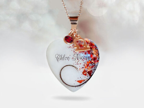 breast milk jewelry heart necklace with rose gold and red ruby flakes and lock of hair from a baby, name and red charm with zodiac charm from keepsakemom