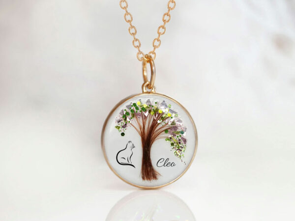 memorial jewelry, a necklace for a cat owner with a tree shaped from pet's fur with green and rose flakes and a pet outline printed on the left side of the tree and the cat's name on the right side, a pendant is made from rose gold with a rose gold chain from keepsakemom