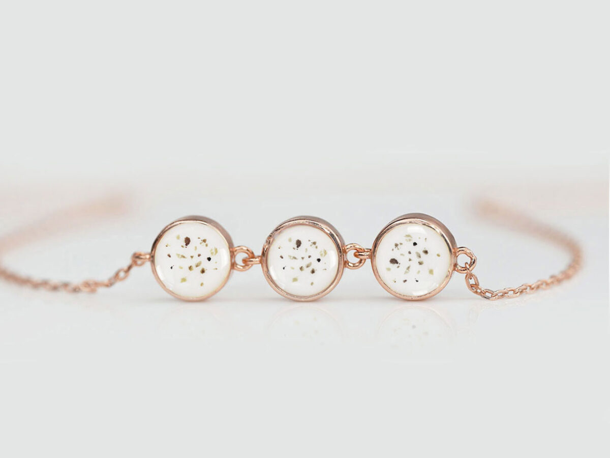 Keepsake Memorial Jewelry Ashes Keepsakemom Silver Gold (13) memorial keepsake jewelry disc bracelet filled with breastmilk and ashes sprinkled in every of the three discs on light background from keepsakemom