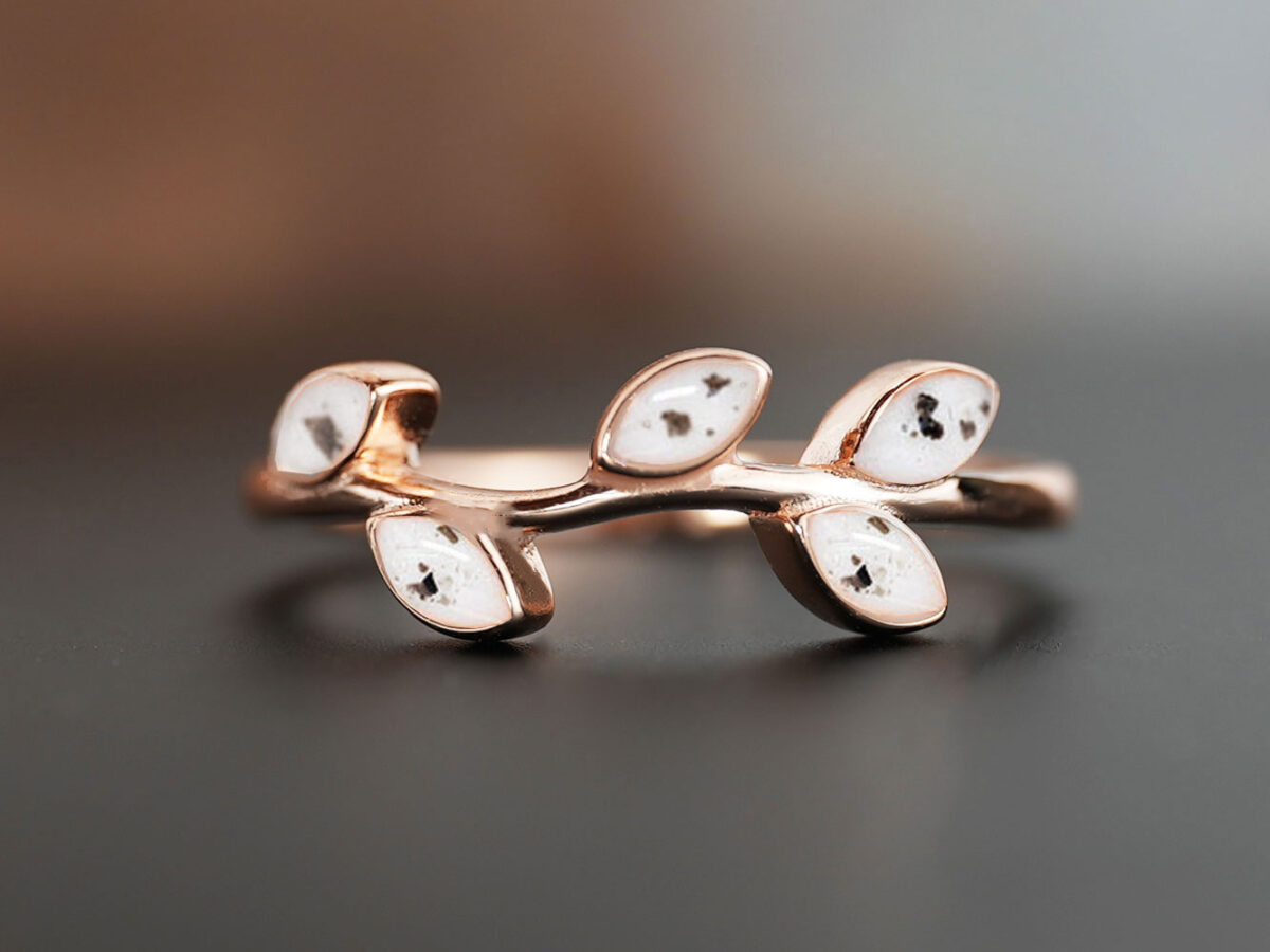 memorial ring branch style with 5 leaves filled with breastmilk and ashes in rose gold on dark background from keepsakemom