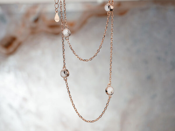 cremation memorial necklace with 4 tiny discs filled with breastmilk simulation and ashes in black color on rose gold quality chain from keepsakemom dangling in two layers