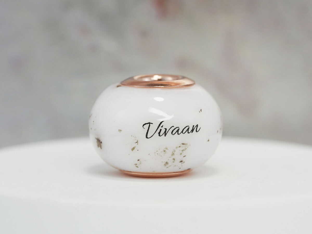 keepsake pandora style bead cremation jewelry with ashes, lock of hair and name from keepsakemom on white background