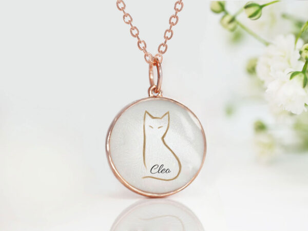 memorial jewelry, a necklace for pet owners with a cat outline formed from cat's fur in a small rose gold disc filled with white resin from keepsakemom
