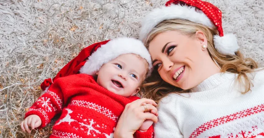 A mom and her baby dressed up in Christmas clothes