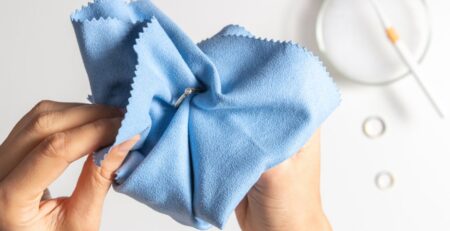 A person polishing a ring