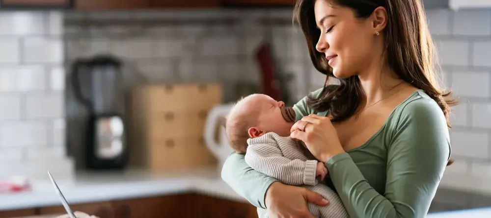 A fashionable mom working from home and taking care of her baby